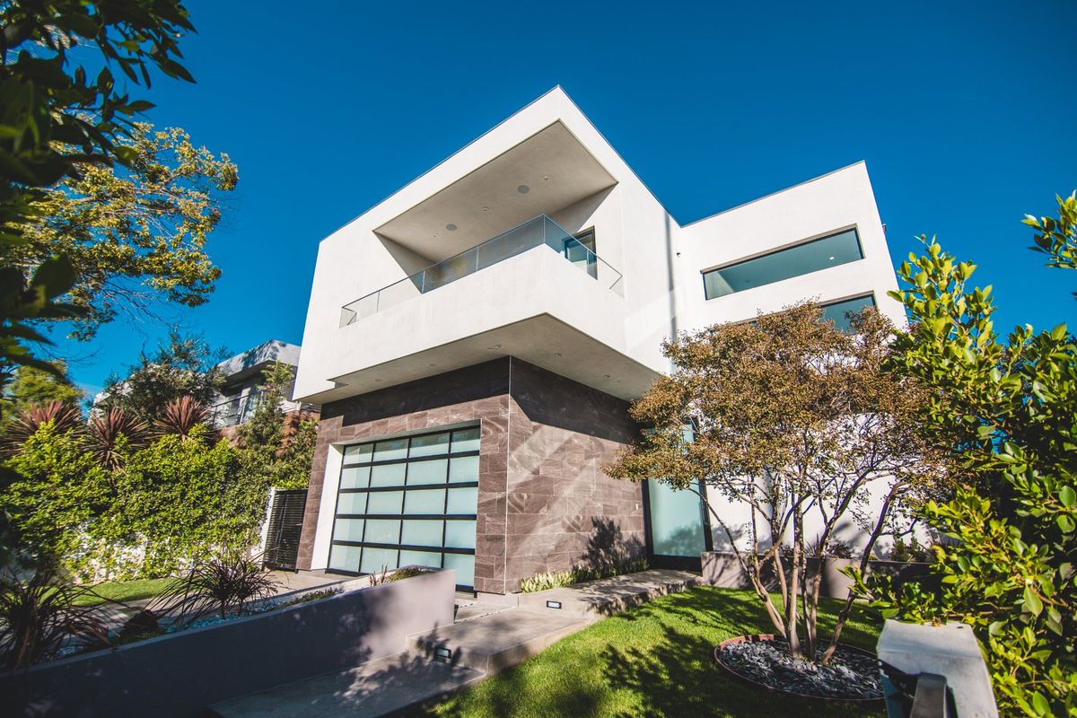 Modern stone and stucco home with three-car garage at 716 North Martel Avenue
